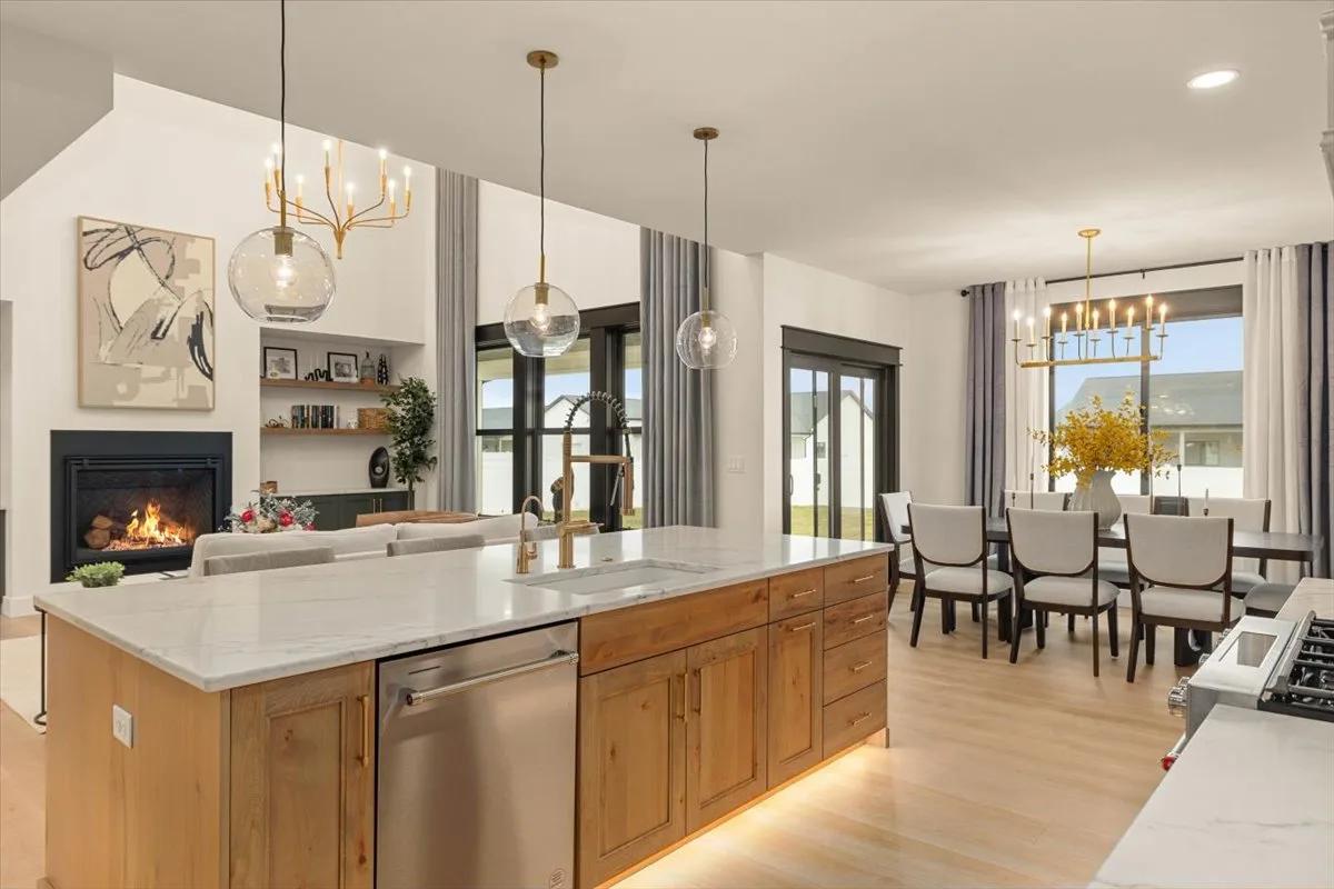 Open-plan view of the Rustic Beech island looking toward dining and living spaces in the Kitchens Plus MT project