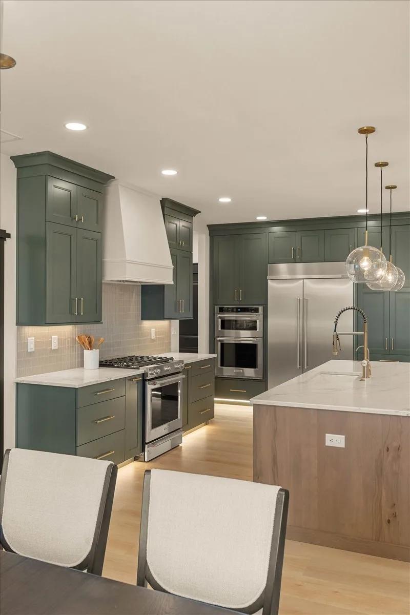Shade Grown perimeter cabinets and Rustic Beech island in a Wynnbrooke American Collection kitchen by Kitchens Plus MT