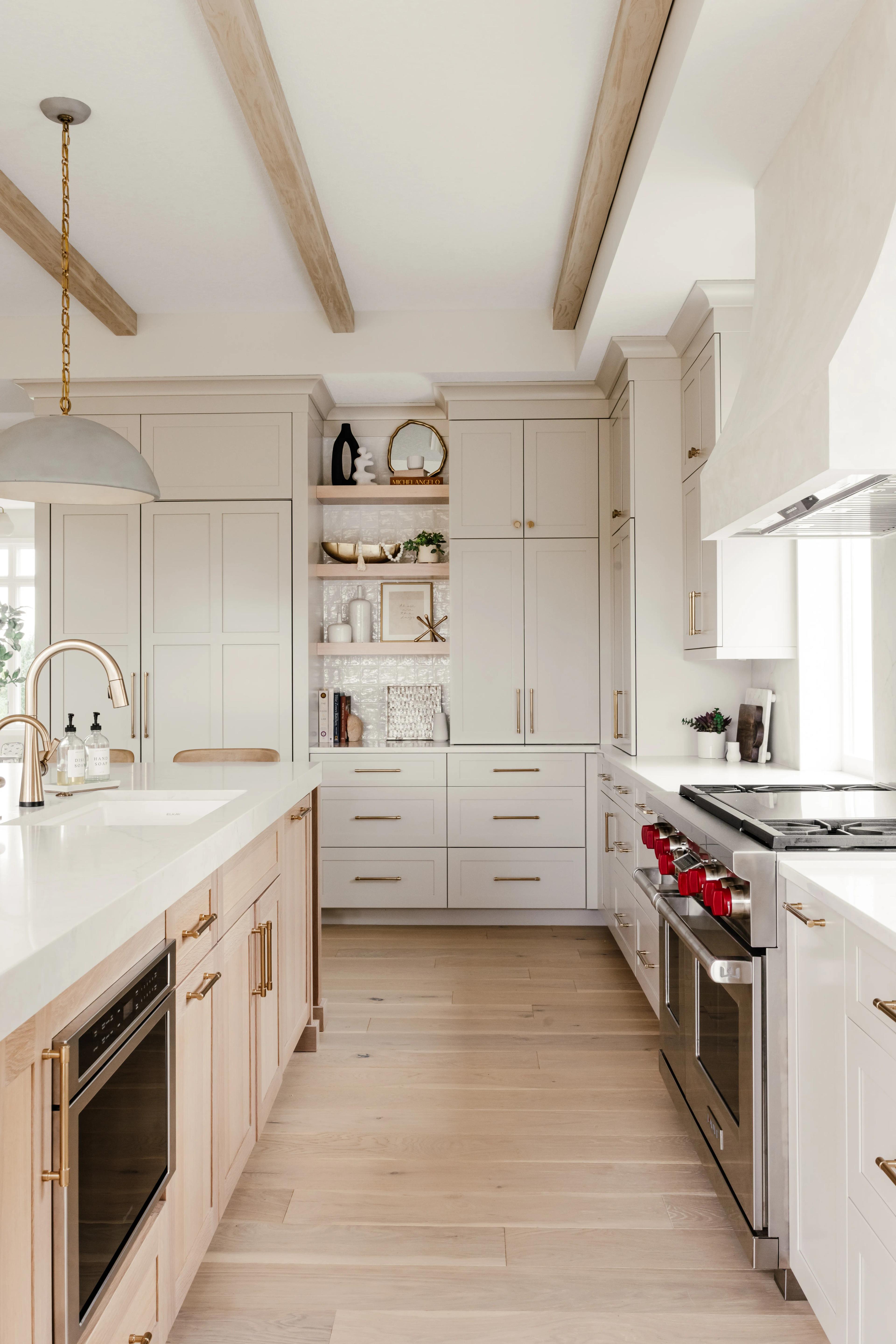 Accessible Beige Plateau perimeter cabinets and a White Oak island in Sand stain, looking toward the range wall
