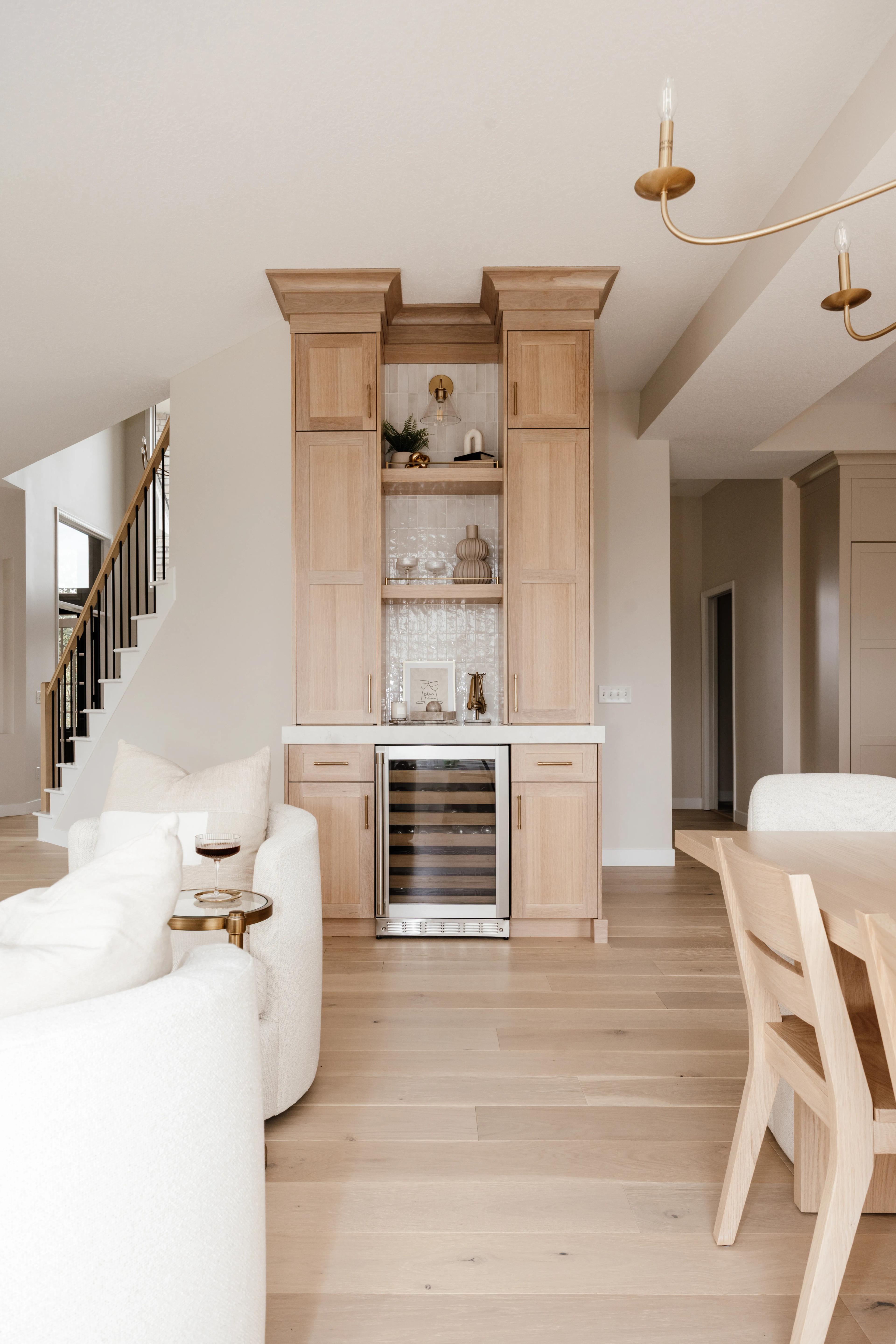 White Oak dry bar in Sand stain with a wine fridge, open shelves, and tiled backsplash by Revival House Design